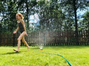 kid playing in backyard of kent county property