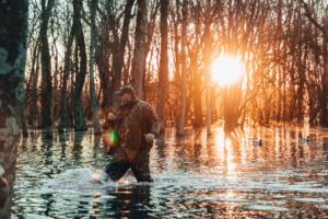 man in water on hunting land